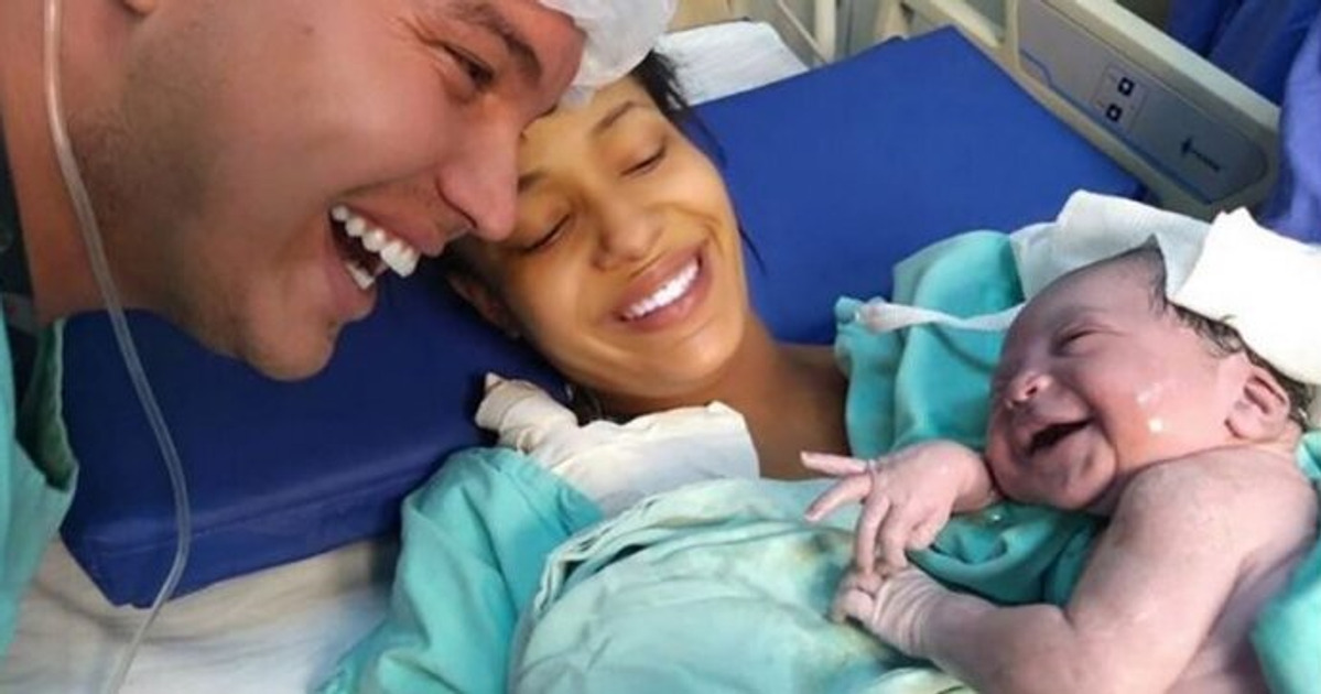 A Newborn Baby Smiles at Father Showing Everyone What True Love Is