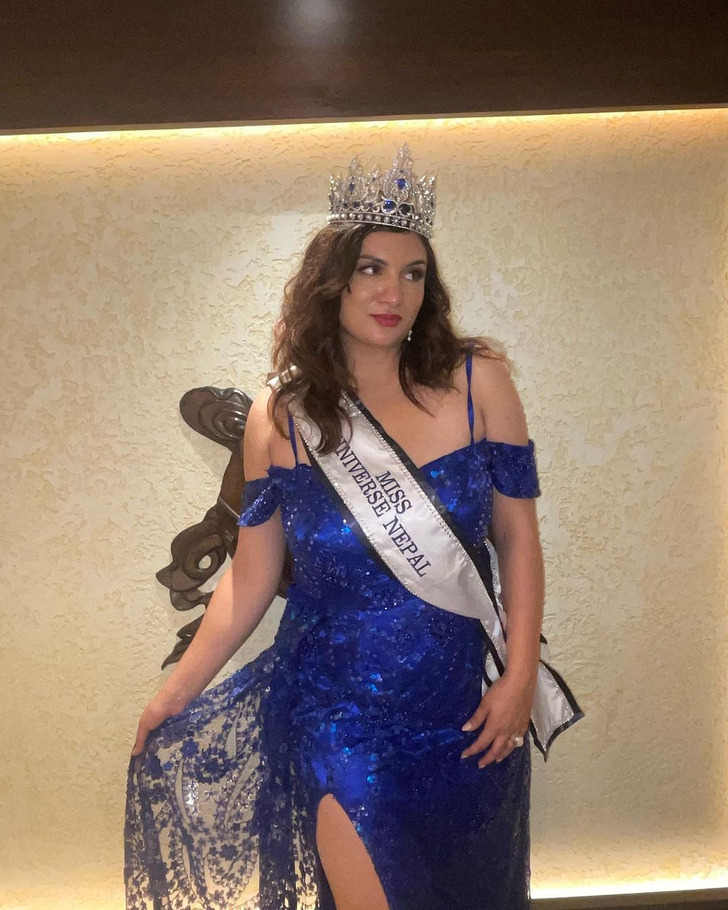 Miss Universe Nepal wearing her crown and blue dress.