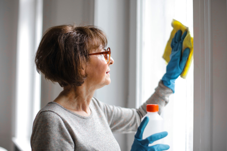 Woman cleaning a window.